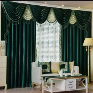 Custom green drapes framing a bright living room window