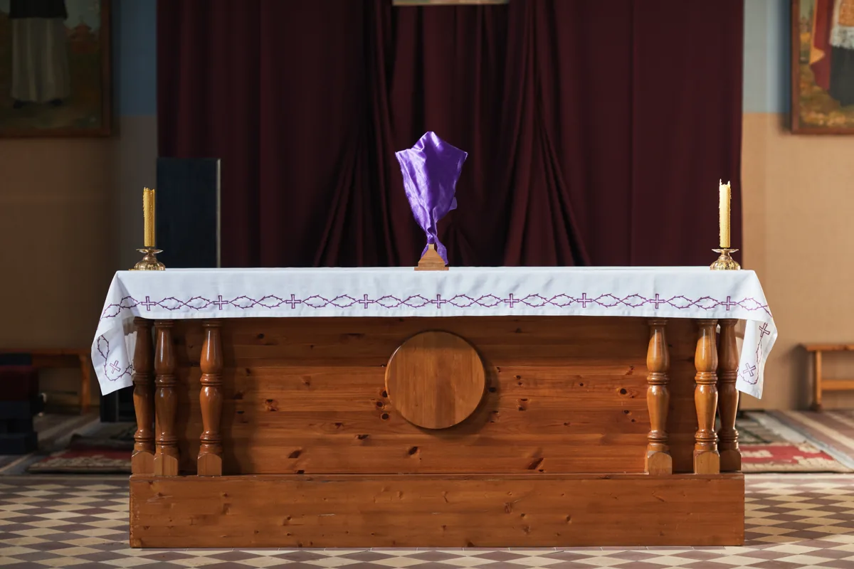 Church altar framed by burgundy drapery