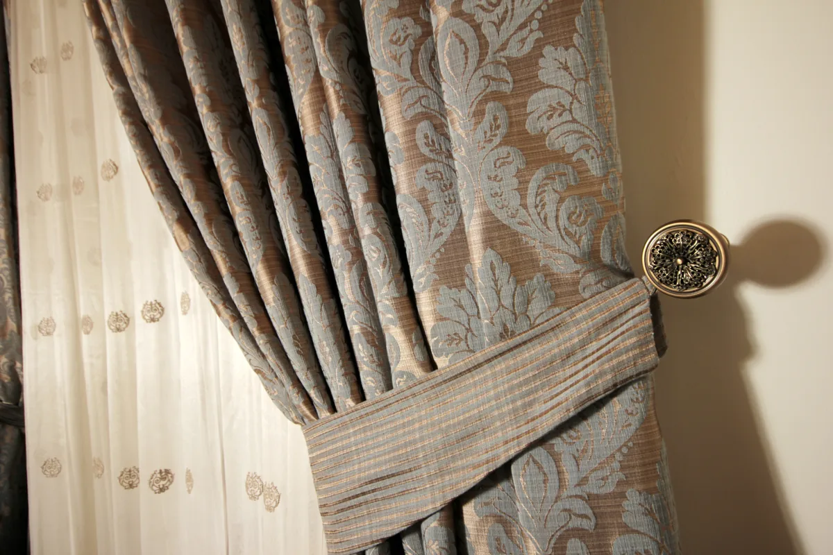 Textured drapery finished with a decorative tieback