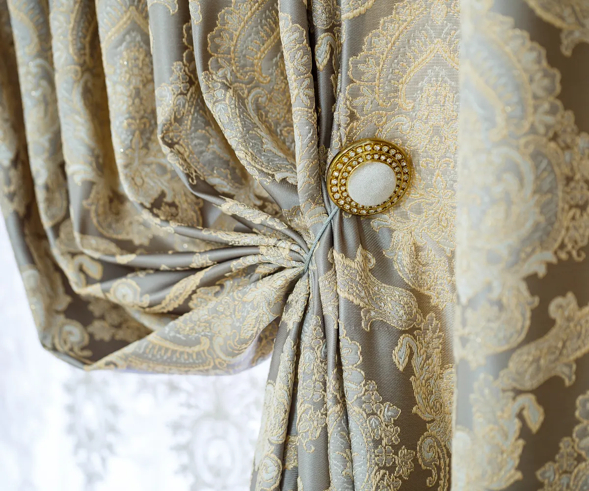 Taupe floor-length curtains framing a softly lit window