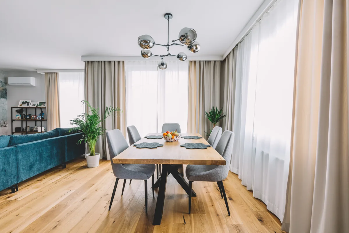 Floor-length curtains framing a bright furnished room